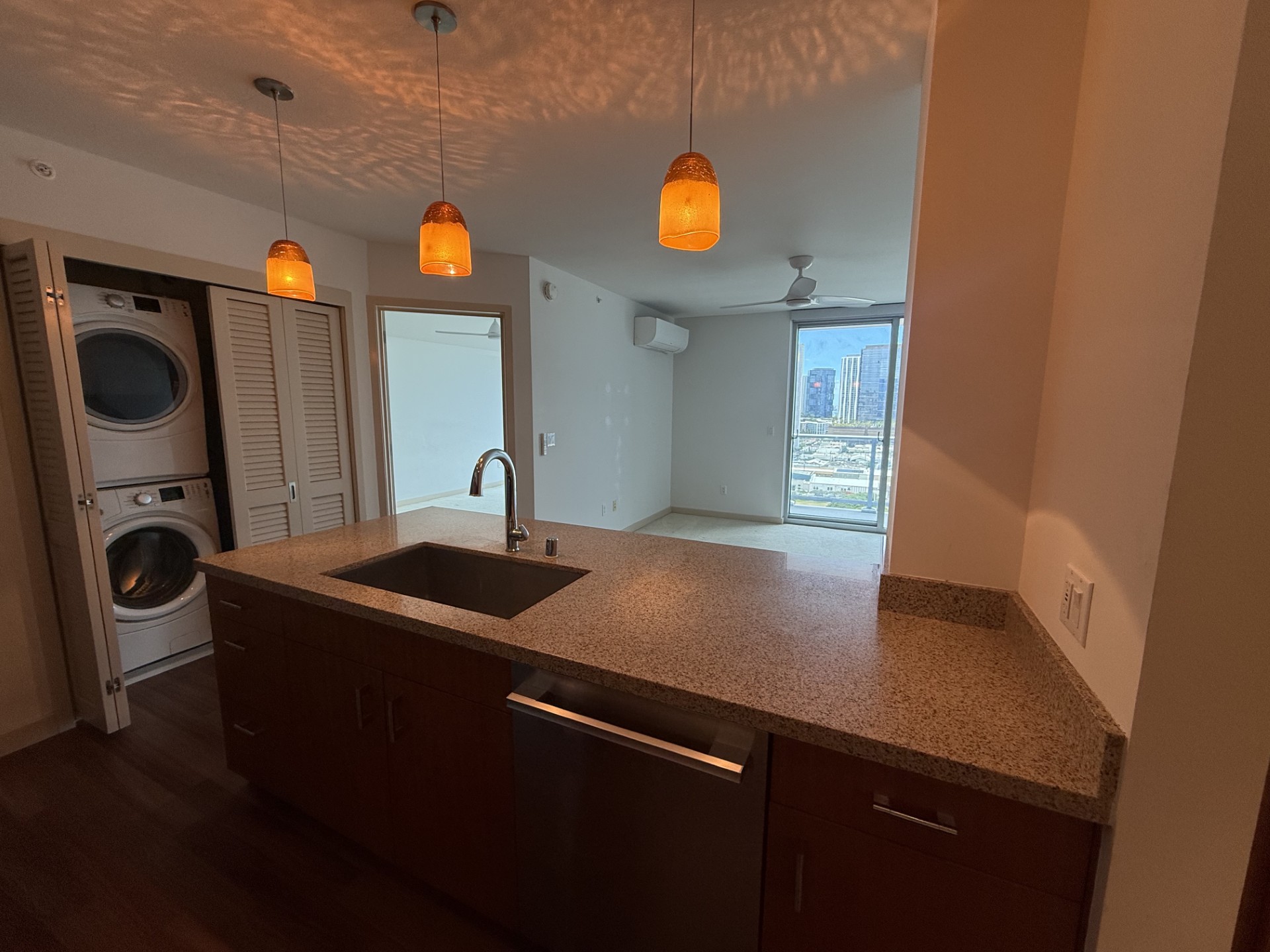 A kitchen with a sink and a washing machine.